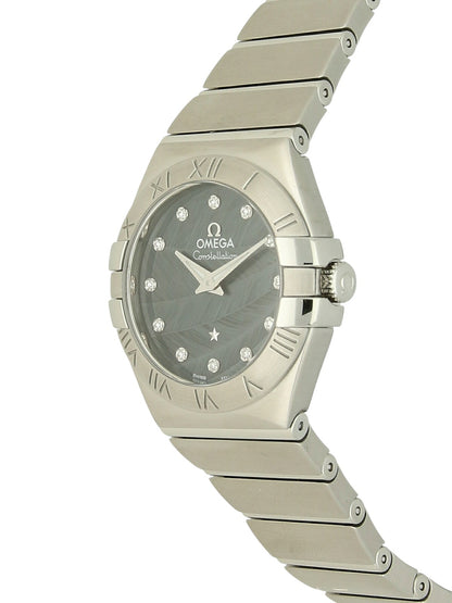 Omega Constellation with steel bracelet and blue  feather, diamond-set dial on a white background.