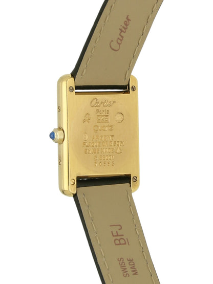 Yellow gold Cartier watch with a black leather strap and grey dial on a white background.