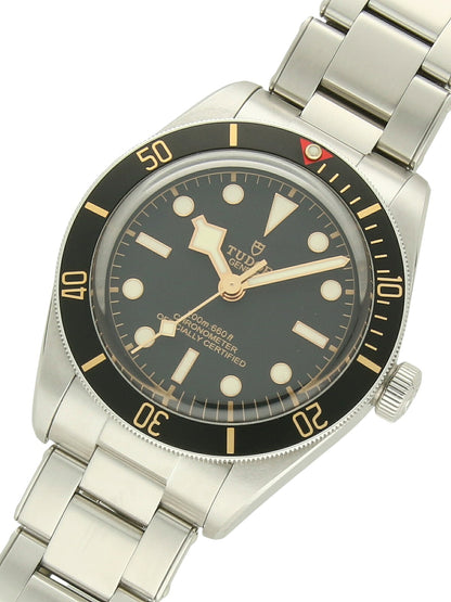 TUDOR Black Bay 58 with steel case, steel bracelet and black dial on a white background.