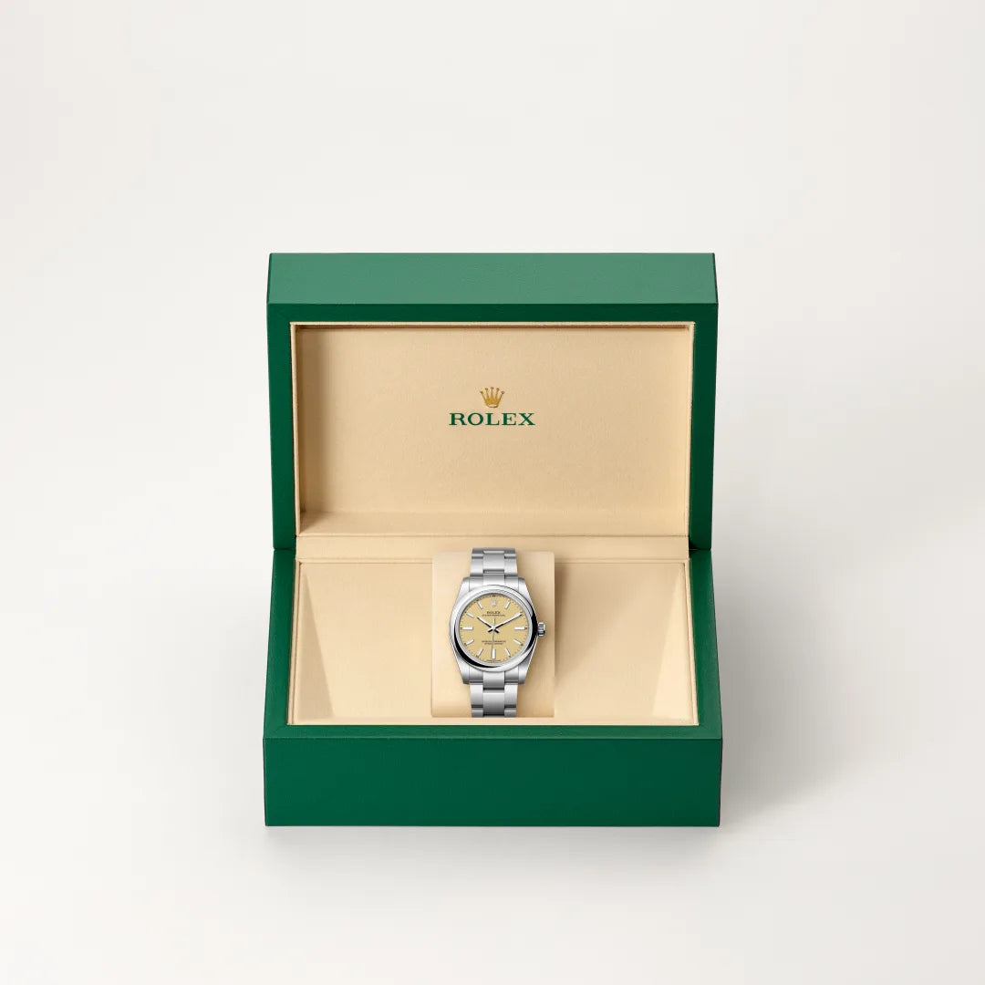 Rolex Oyster Perpetual watch in a green and beige presentation box on a light background.