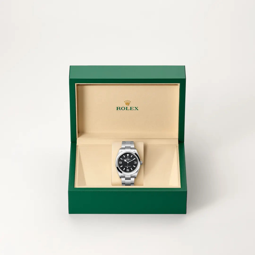 Rolex Oyster Perpetual watch in a green and beige presentation box on a light background.