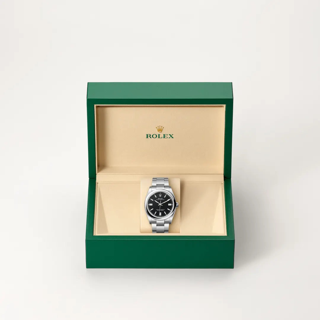 Rolex Oyster Perpetual watch in a green and beige presentation box on a light background.