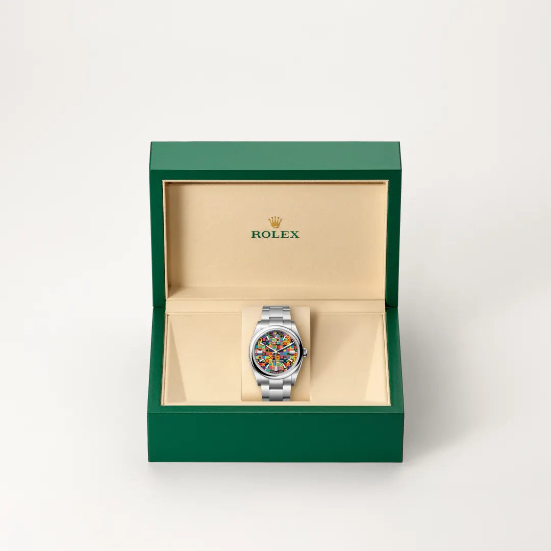 Rolex Oyster Perpetual watch in a green and beige presentation box on a light background.