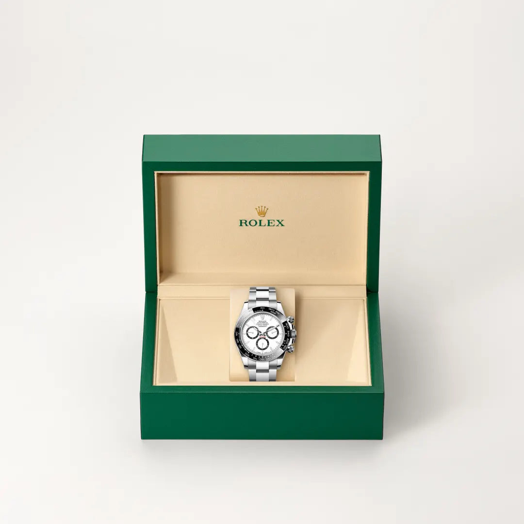 Rolex Cosmograph Daytona watch in a green and beige presentation box on a light background.