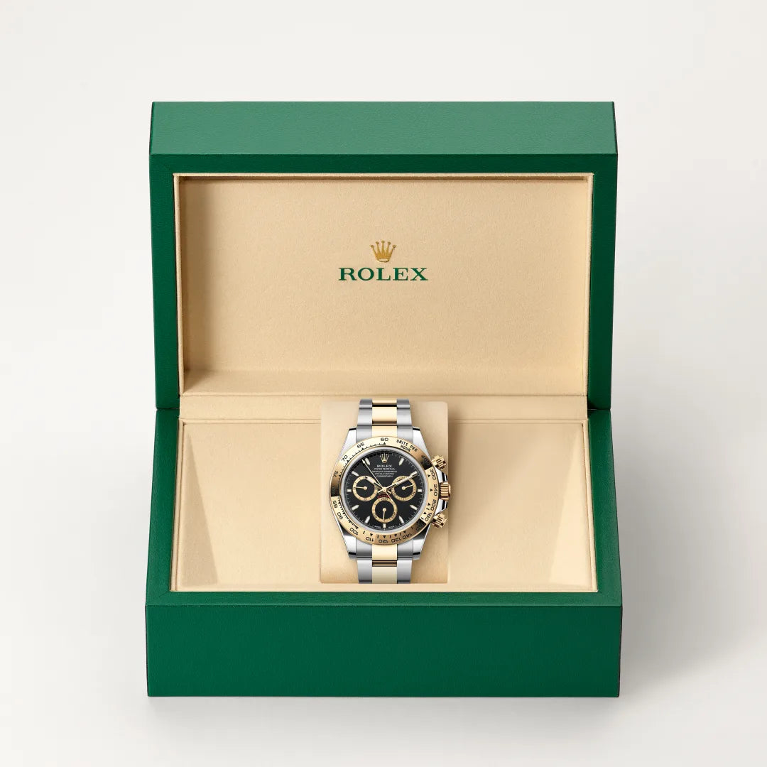Rolex Cosmograph Daytona watch in a green and beige presentation box on a light background.