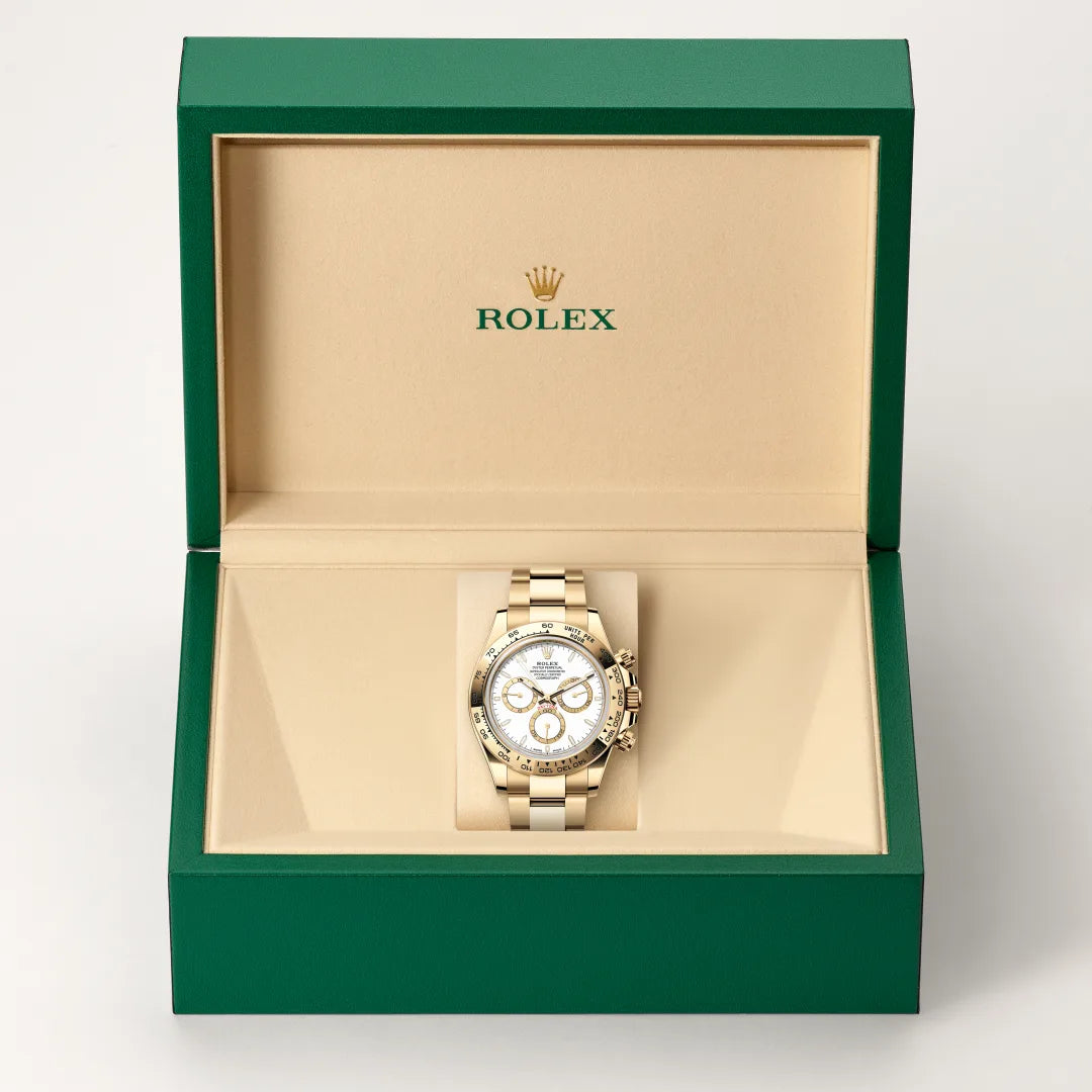 Rolex Cosmograph Daytona watch in a green and beige presentation box on a light background.