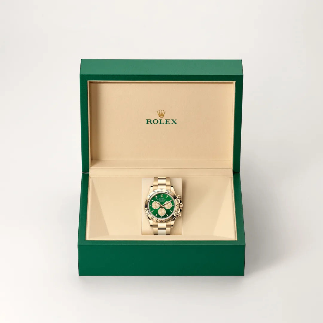 Rolex Cosmograph Daytona watch in a green and beige presentation box on a light background.