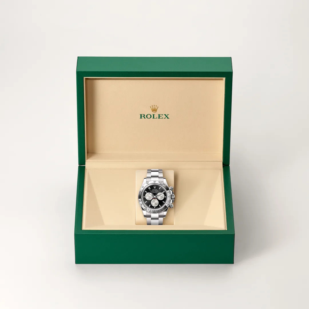 Rolex Cosmograph Daytona watch in a green and beige presentation box on a light background.