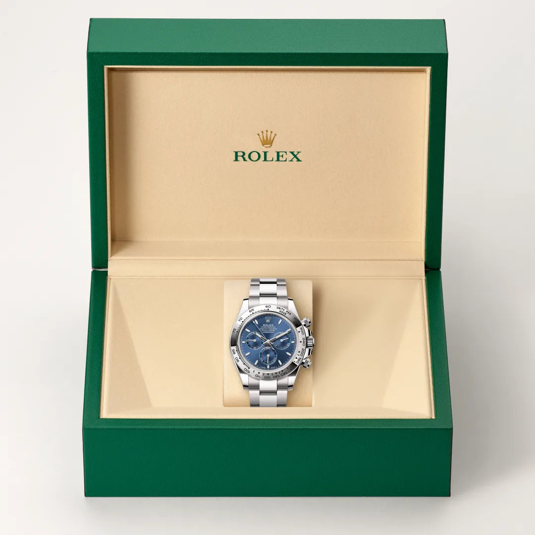 Rolex Cosmograph Daytona watch in a green and beige presentation box on a light background.