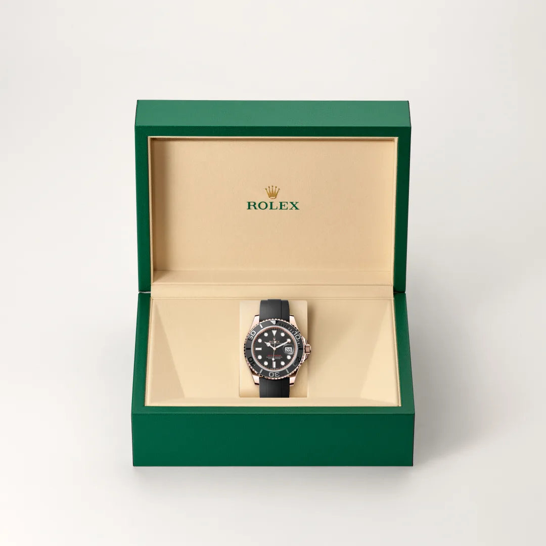 Rolex Yacht-Master watch in a green and beige presentation box on a light background.