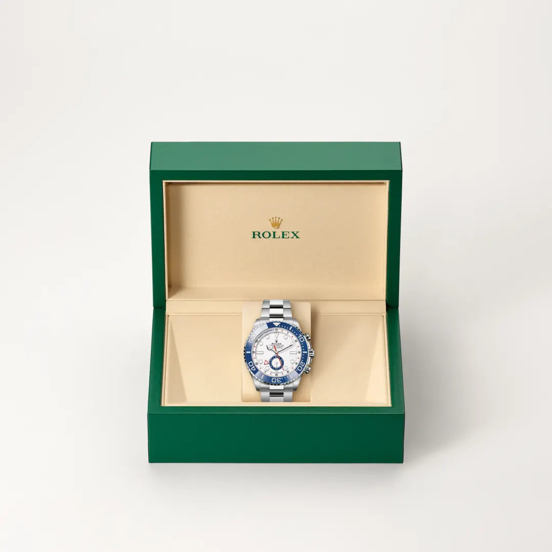 Rolex Yacht-Master II watch in a green and beige presentation box on a light background.