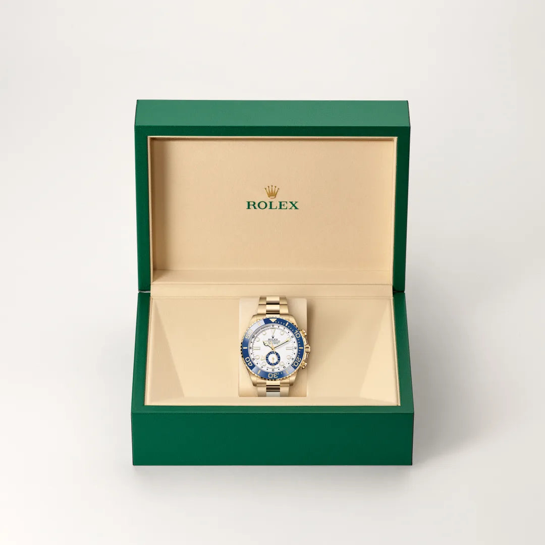 Rolex Yacht-Master II watch in a green and beige presentation box on a light background.
