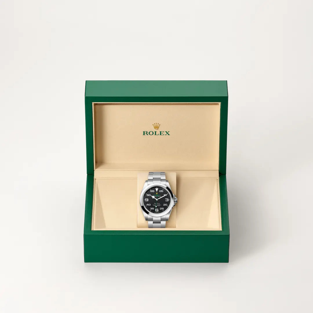 Rolex Air-King watch in a green and beige presentation box on a light background.