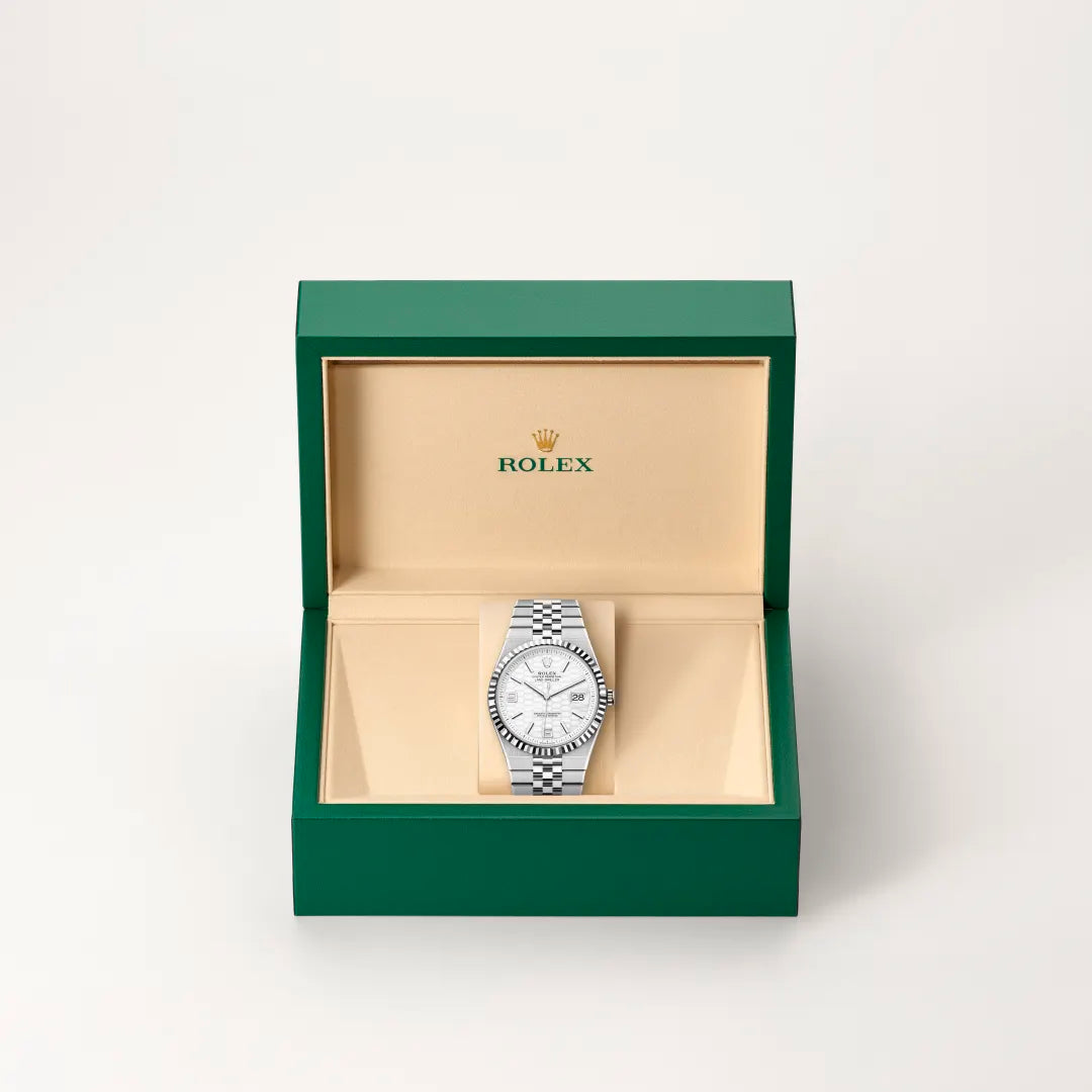 Rolex 1908 watch in a green and beige presentation box on a light background.