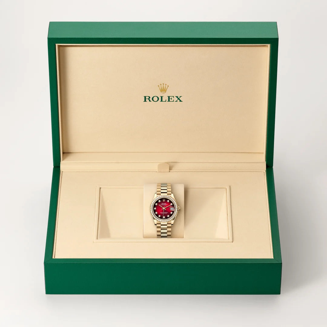 Rolex Datejust watch in a green and beige presentation box on a light background.