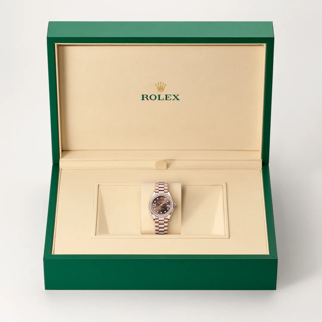 Rolex Lady-Datejust watch in a green and beige presentation box on a light background.