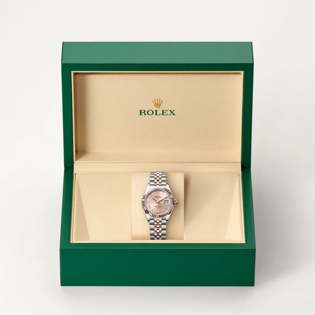 Rolex Lady-Datejust watch in a green and beige presentation box on a light background.