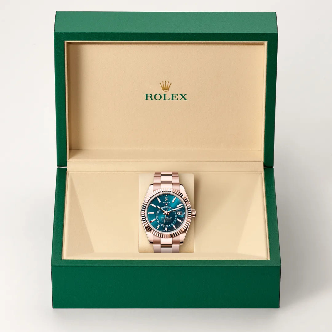 Rolex Sky-Dweller watch in a green and beige presentation box on a light background.