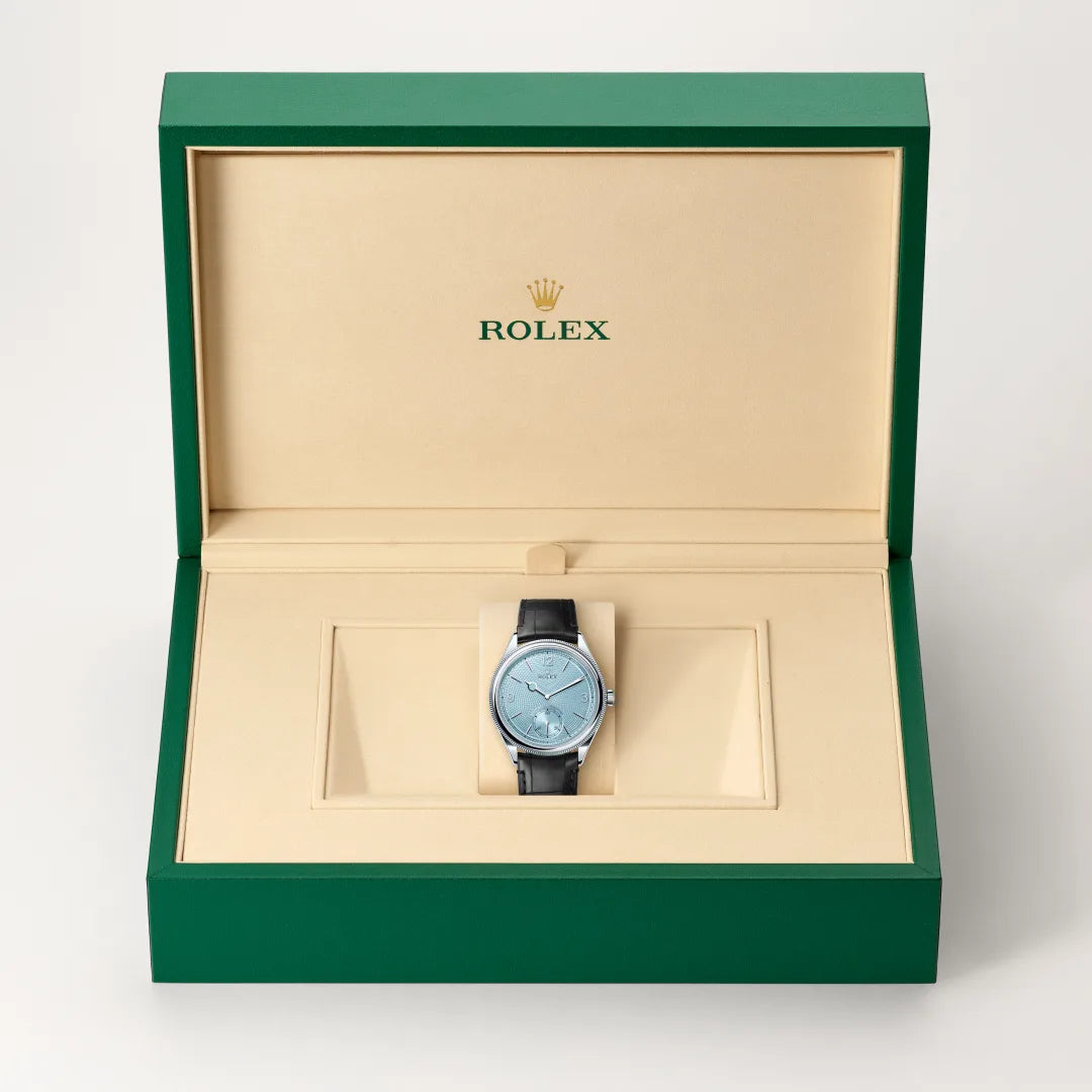 Rolex 1908 watch in a green and beige presentation box on a light background.