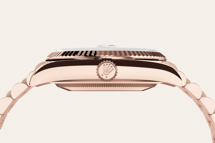 Side-profile of a rose-gold Rolex Datejust watch on a light background.