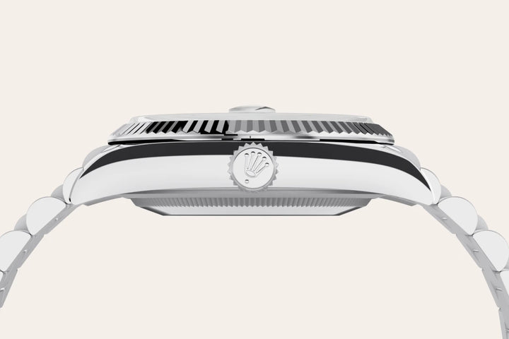 Side-profile of a platinum Rolex Day-Date watch with logo crown on a white background.