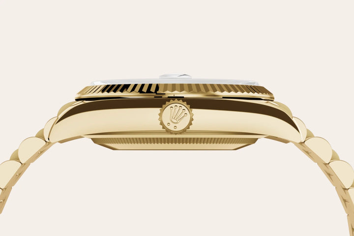 Side profile of a yellow-gold Rolex Day-Date watch with logo crown on a white background. 