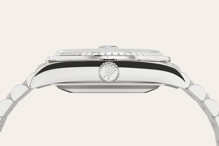 Side-profile of a white gold Rolex Day-Date watch with logo crown on a white background.