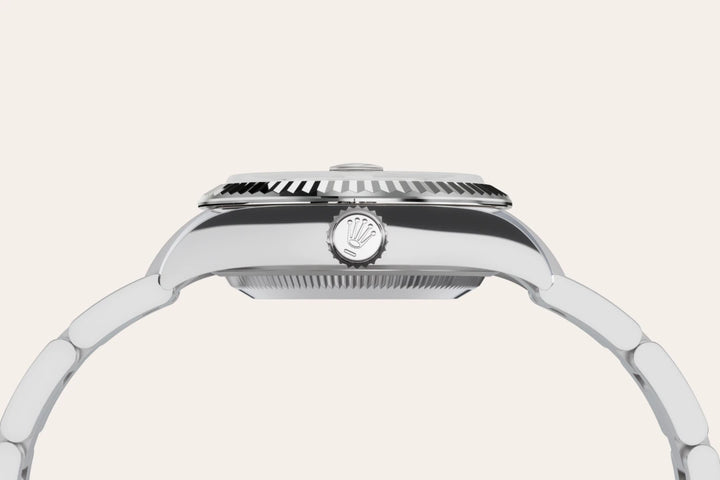 Side-profile of Rolex watch with logo crown on a light background.