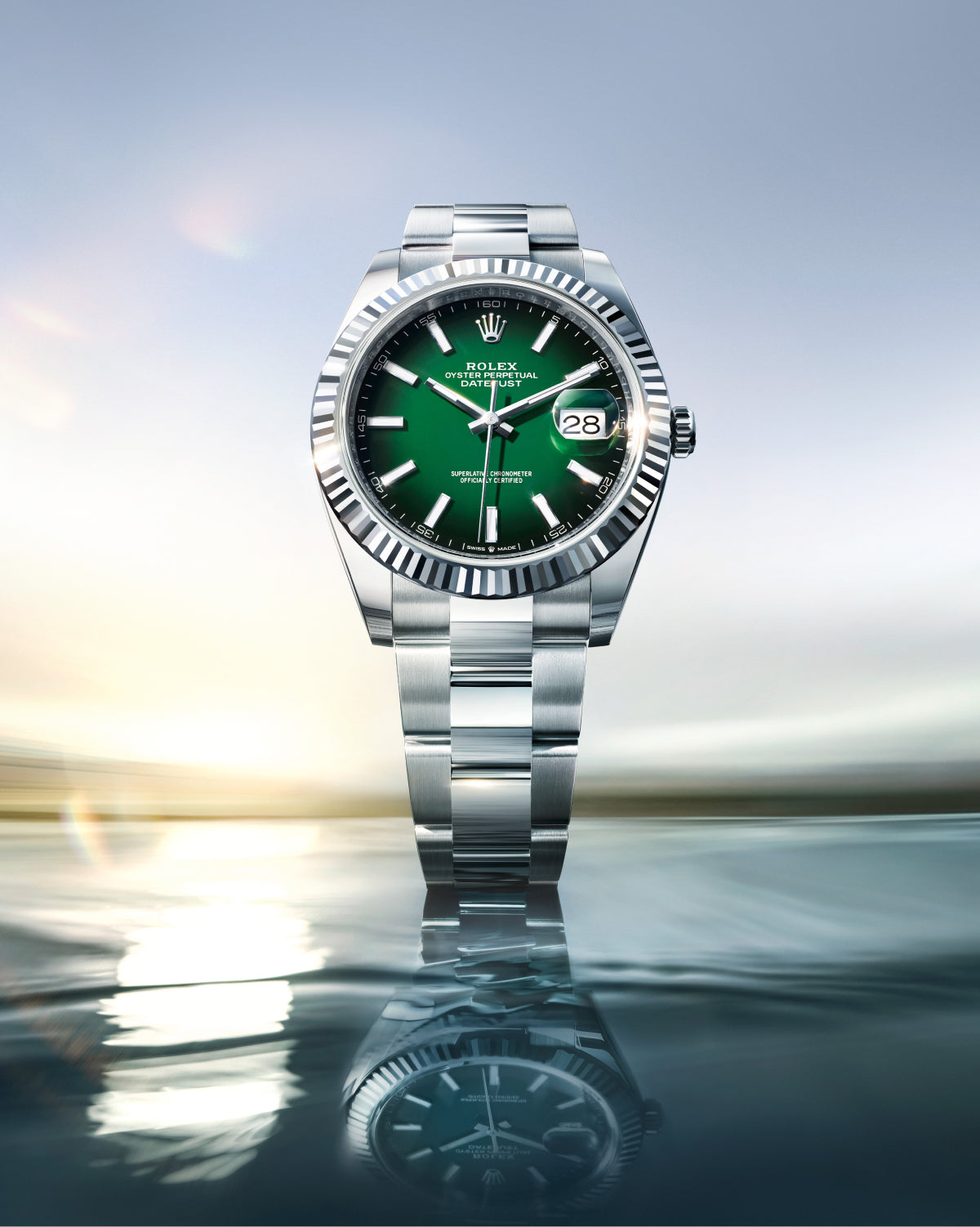 Rolex Datejust 41 watch with an Oyster bracelet and green dial on a reflective background.