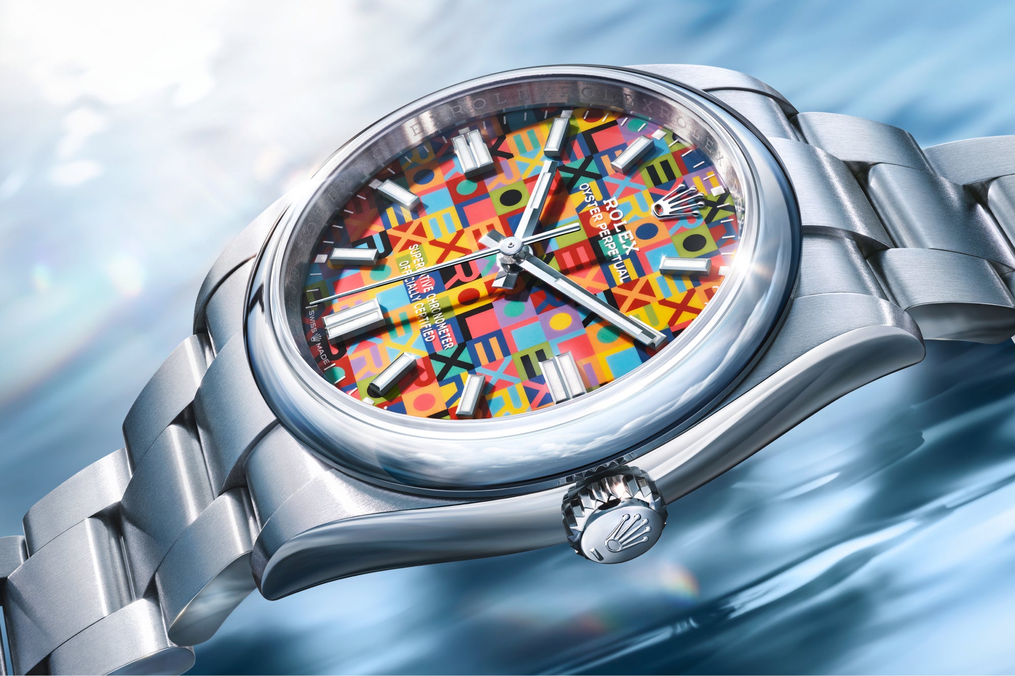 Rolex Oyster Perpetual 36 watch with a steel bracelet and multicolour dial on a reflective background.