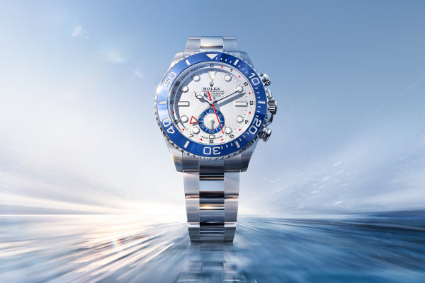 Rolex Yacht-Master II watch with a steel bracelet and white dial on a sky and sea background.