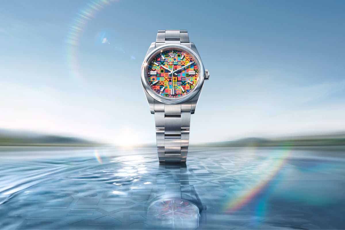 Rolex Oyster Perpetual 36 watch with a steel bracelet and multicolour dial on a reflective background.