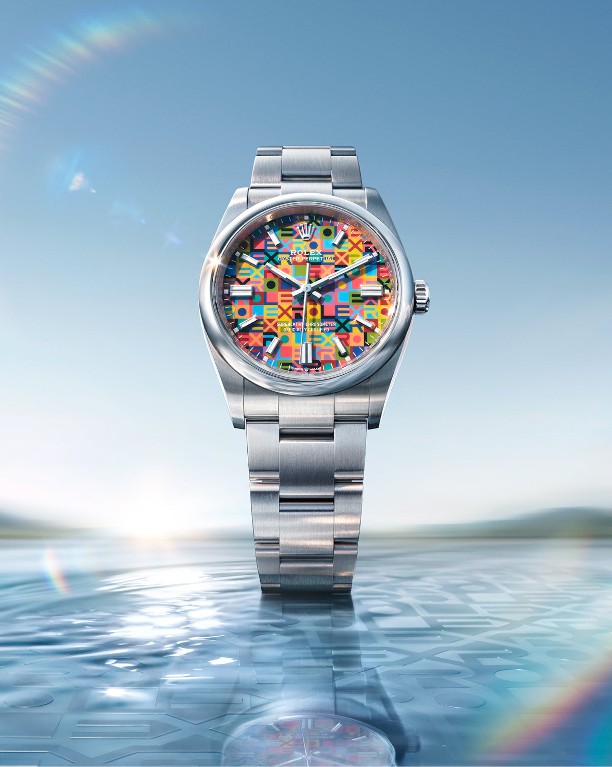 Rolex Oyster Perpetual 36 watch with a steel bracelet and multicolour dial on a reflective background.
