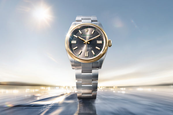 Rolex Oyster Perpetual 41 watch with a steel bracelet and slate dial on a sea and sky background.