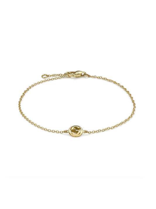 Gucci Interlocking yellow gold bracelet on a white background.