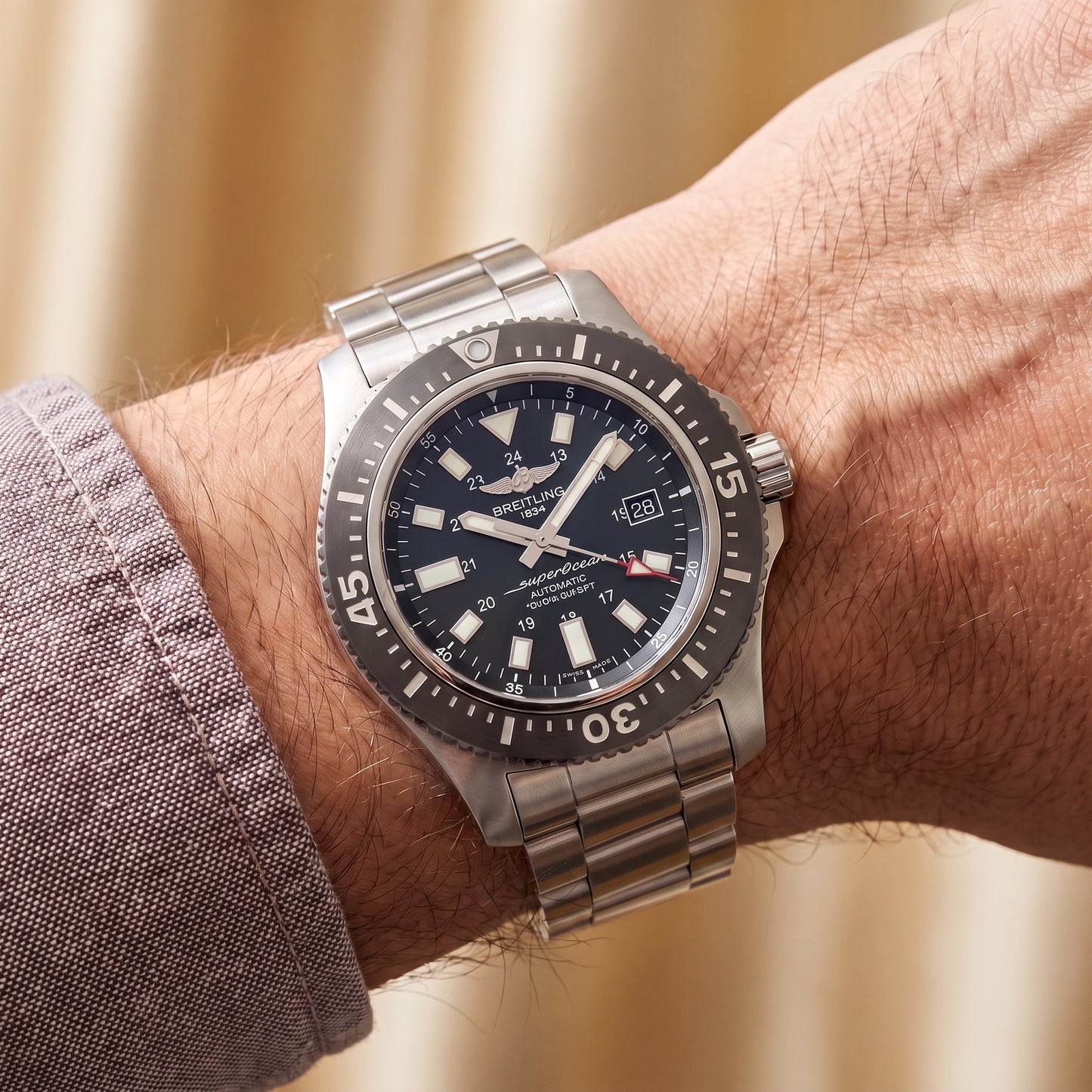 Breitling Superocean with 44mm steel case, steel bracelet and black dial on a gents wrist.