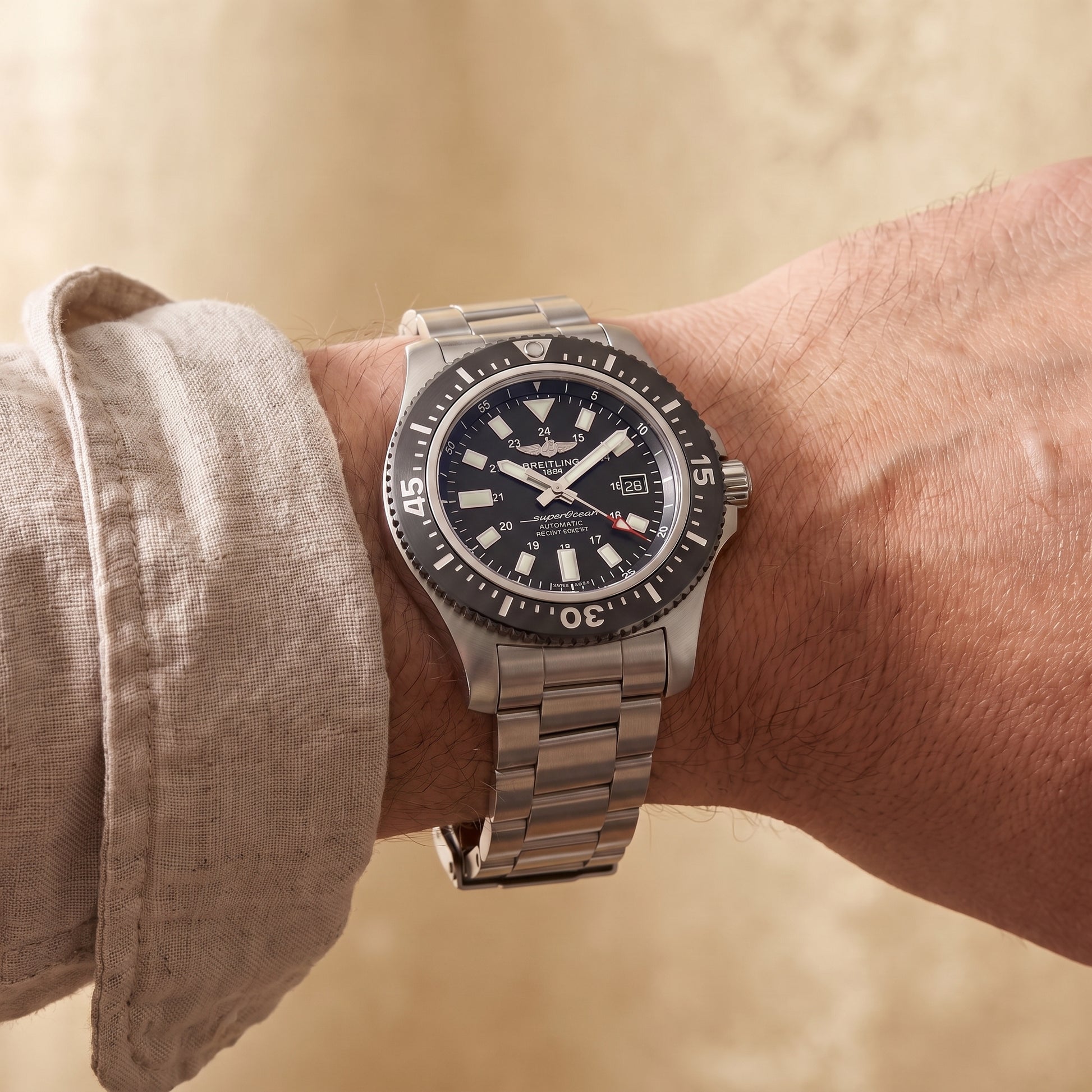 Breitling Superocean with 44mm steel case, steel bracelet and black dial on a gents wrist.