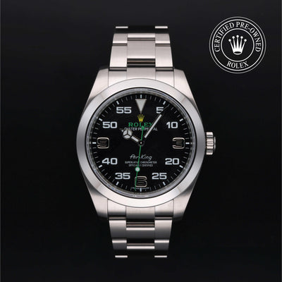 Rolex Air-King watch with a steel Oyster bracelet and black dial on a black background.