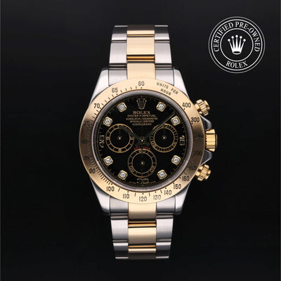 Rolex Cosmograph Daytona with Oystersteel and 18ct yellow gold case, Oyster bracelet & black dial, on a black background.