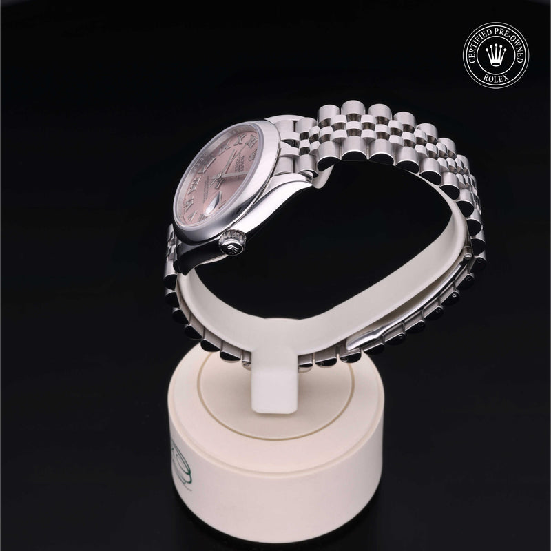 Rolex Datejust watch with a steel Jubilee bracelet and pink dial on a black background.Datejust 31
