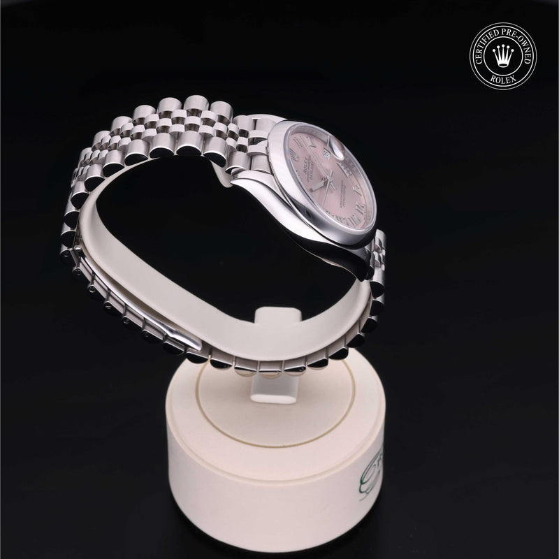 Rolex Datejust watch with a steel Jubilee bracelet and pink dial on a black background.Datejust 31
