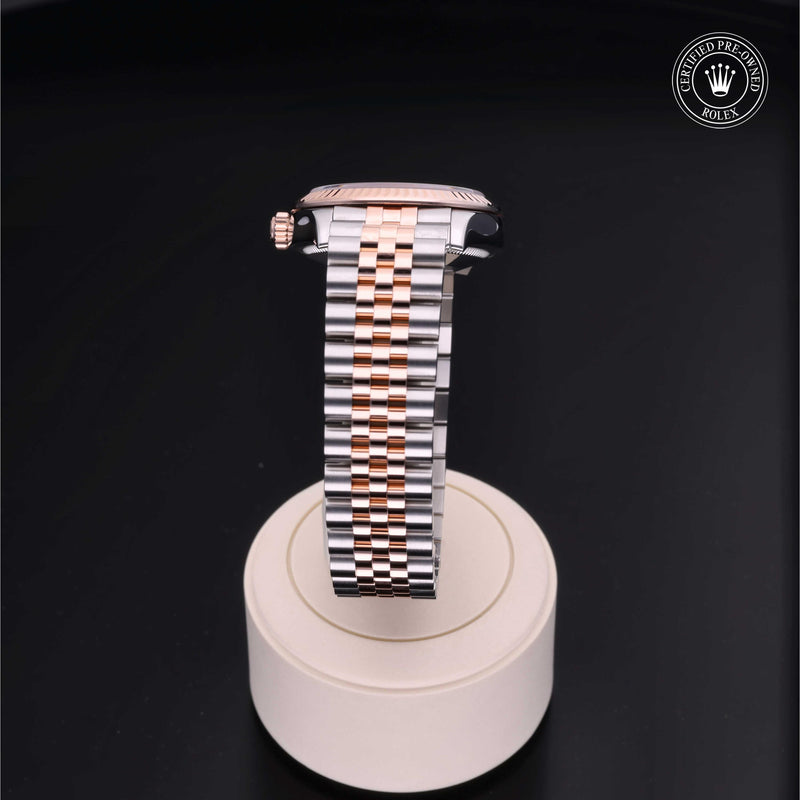 Rolex Datejust 31 with steel & Everose gold Jubilee bracelet and chocolate, diamond-set dial on a cream presentation stand against a black background.Datejust 31