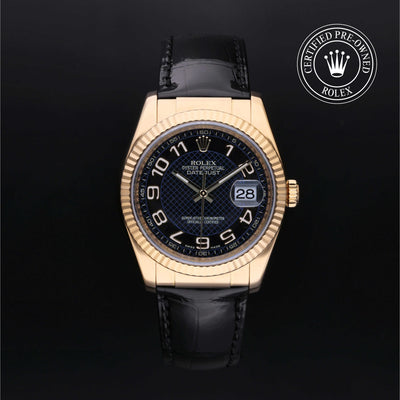Rolex Datejust 36 with 18ct yellow gold case, black leather strap & black dial, against a black background.