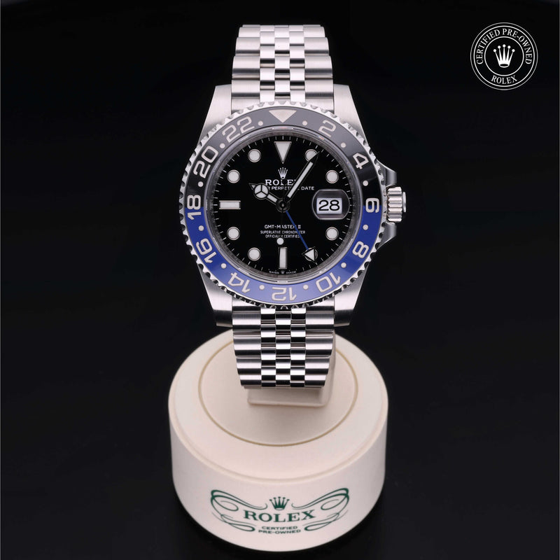 Rolex GMT-Master II watch with steel Jubilee bracelet, black and blue bezel, and black dial on a black background.GMT-Master II