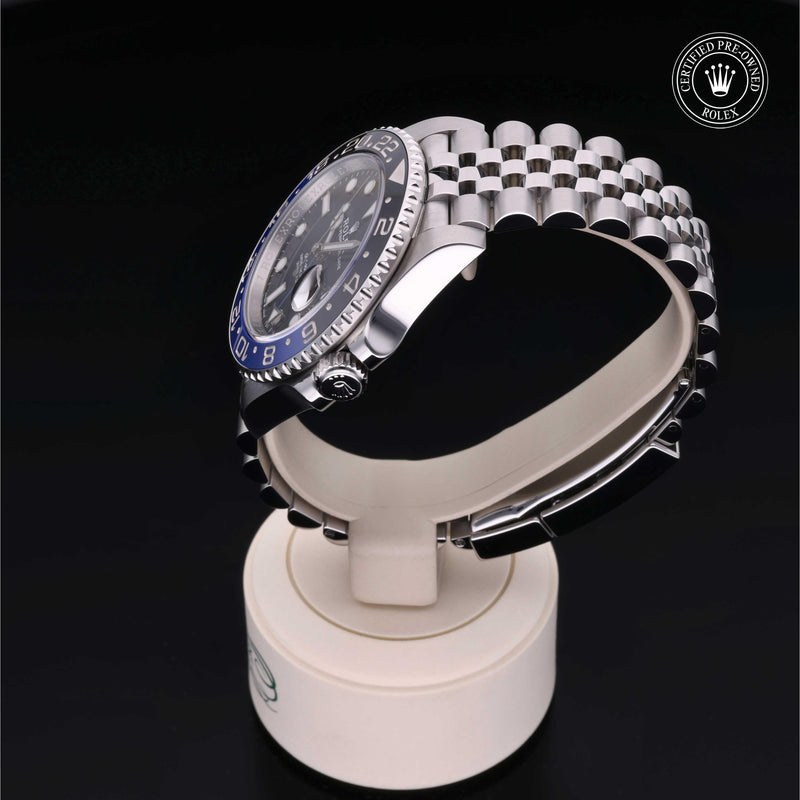 Rolex GMT-Master II watch with steel Jubilee bracelet, black and blue bezel, and black dial on a black background.GMT-Master II