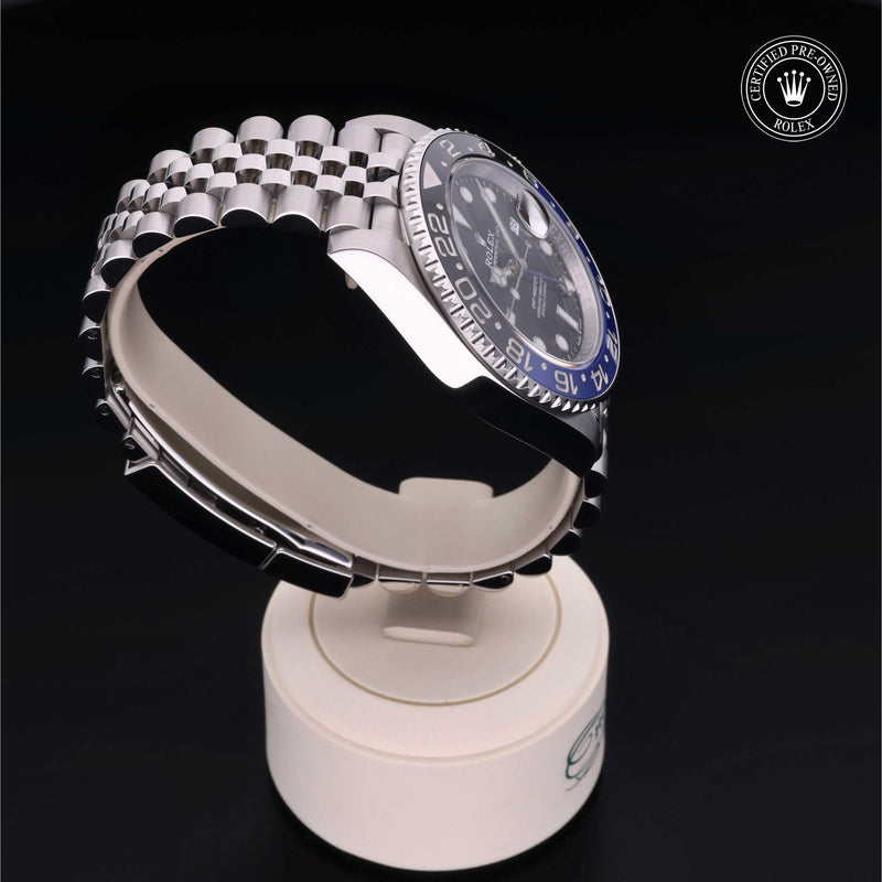 Rolex GMT-Master II watch with steel Jubilee bracelet, black and blue bezel, and black dial on a black background.GMT-Master II