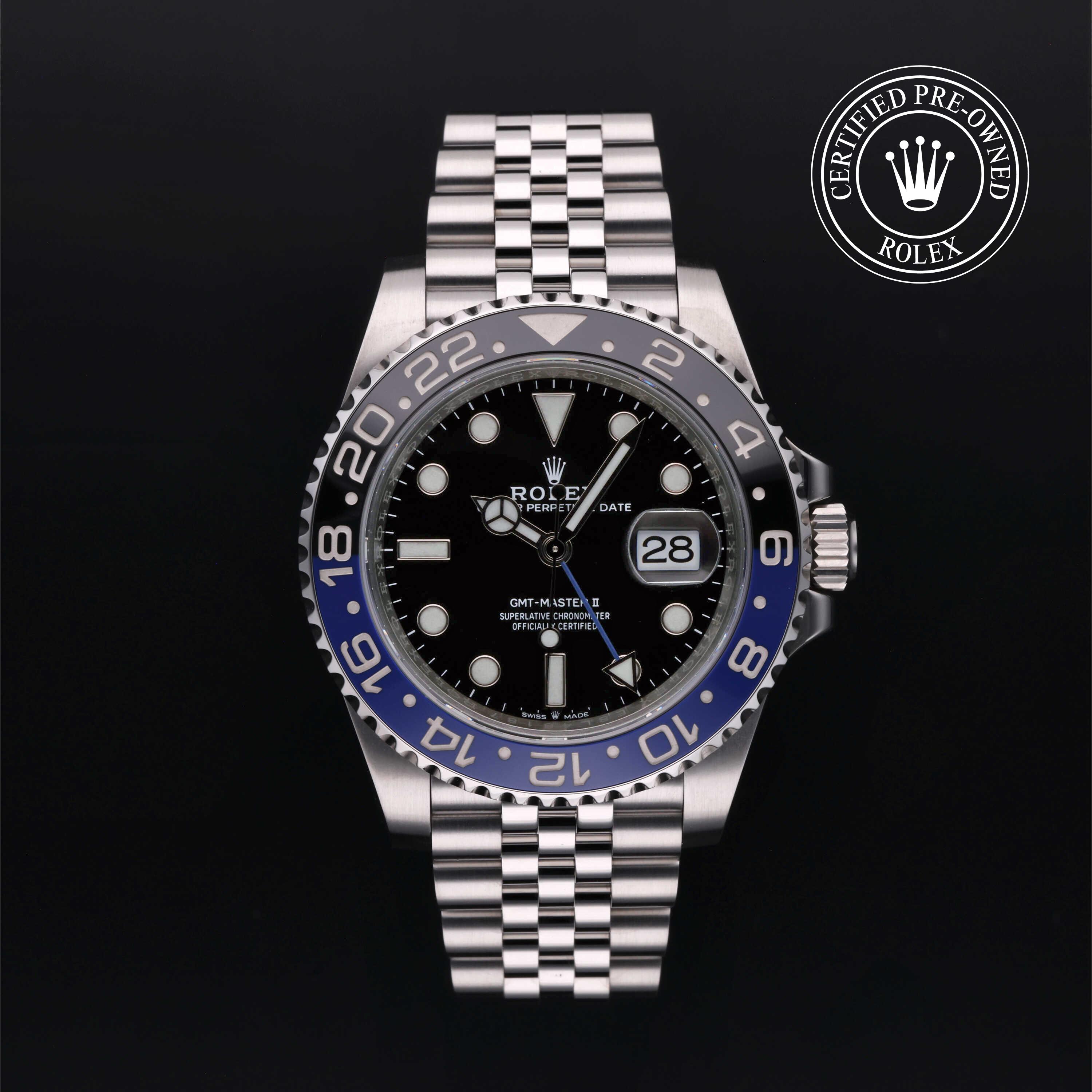 Rolex GMT-Master II watch with steel Jubilee bracelet, black and blue bezel, and black dial on a black background.