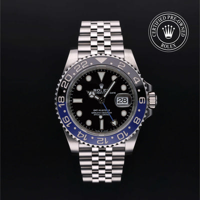 Rolex GMT-Master II watch with steel Jubilee bracelet, black and blue bezel, and black dial on a black background.