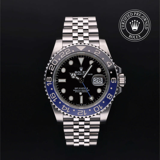 Rolex GMT-Master II watch with steel Jubilee bracelet, black and blue bezel, and black dial on a black background.