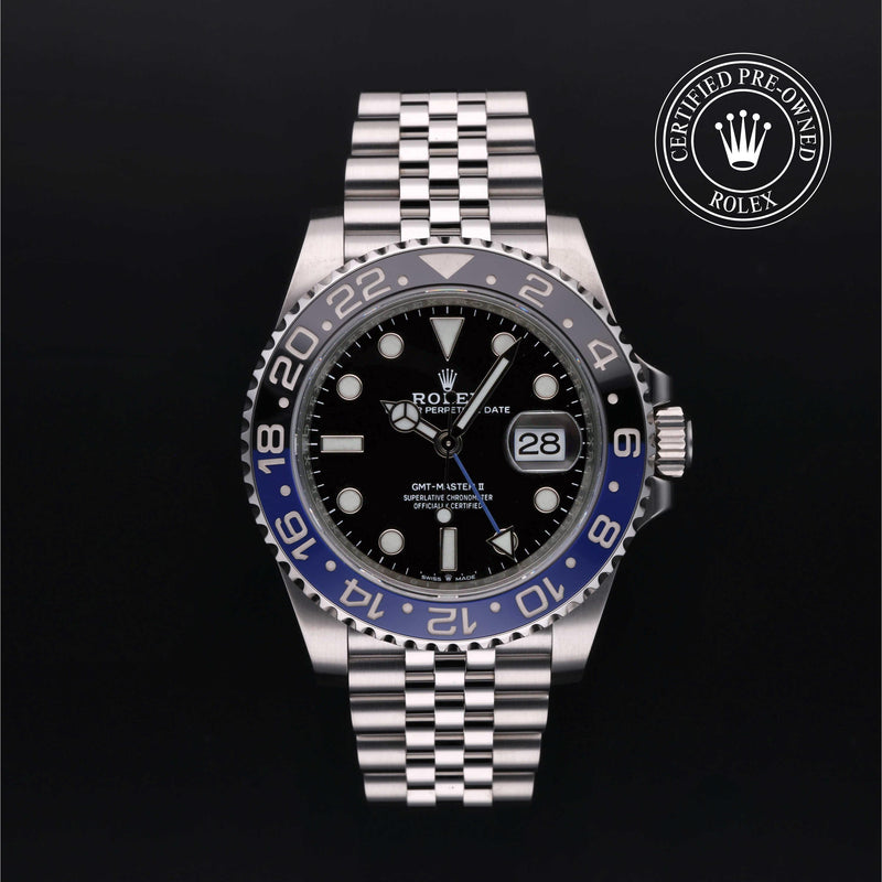 Rolex GMT-Master II watch with steel Jubilee bracelet, black and blue bezel, and black dial on a black background.